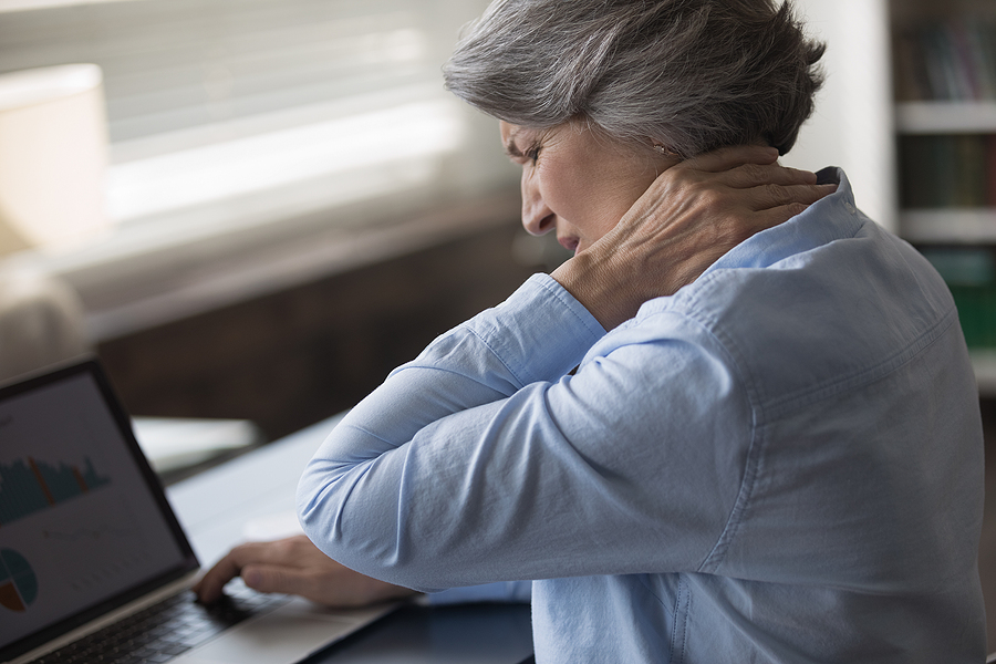 Upset Stressed Mature Woman Suffering From Neck Ache